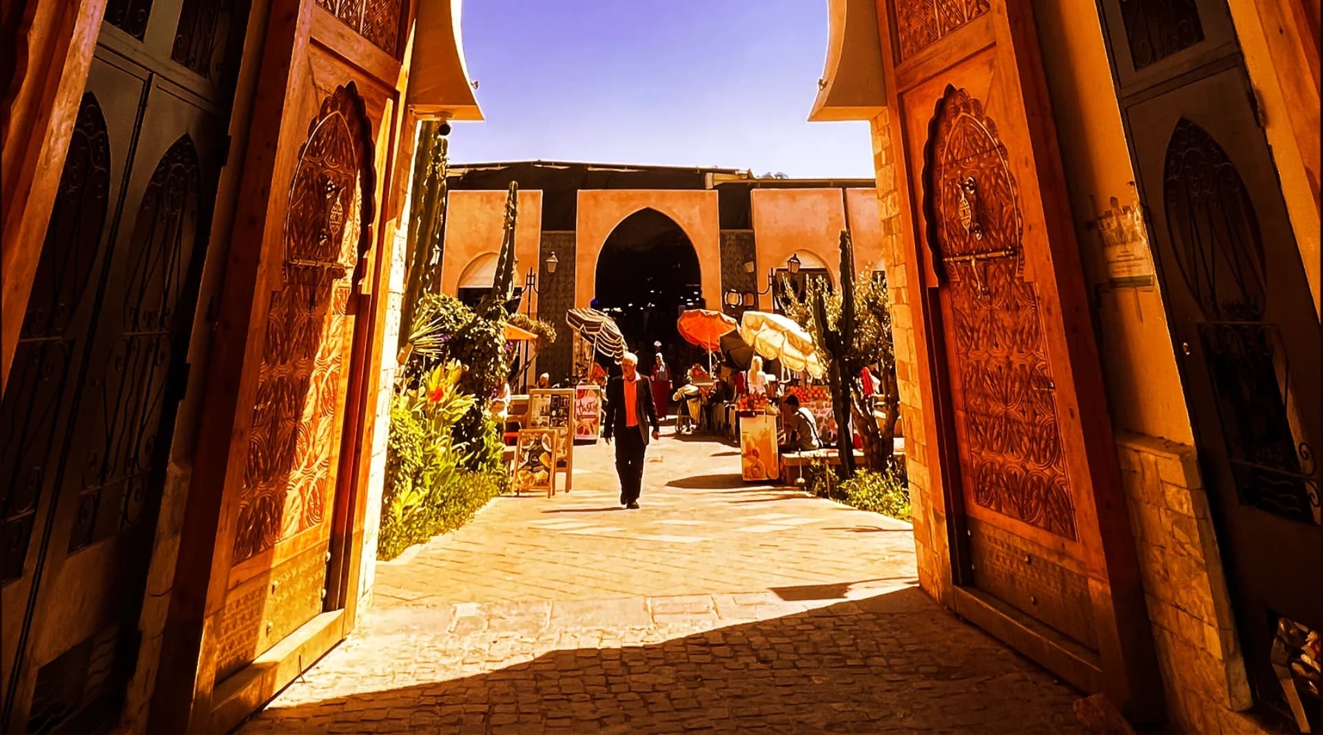 Grand entrance gate of Souk El Had Agadir — sculpted arch and wooden doors
